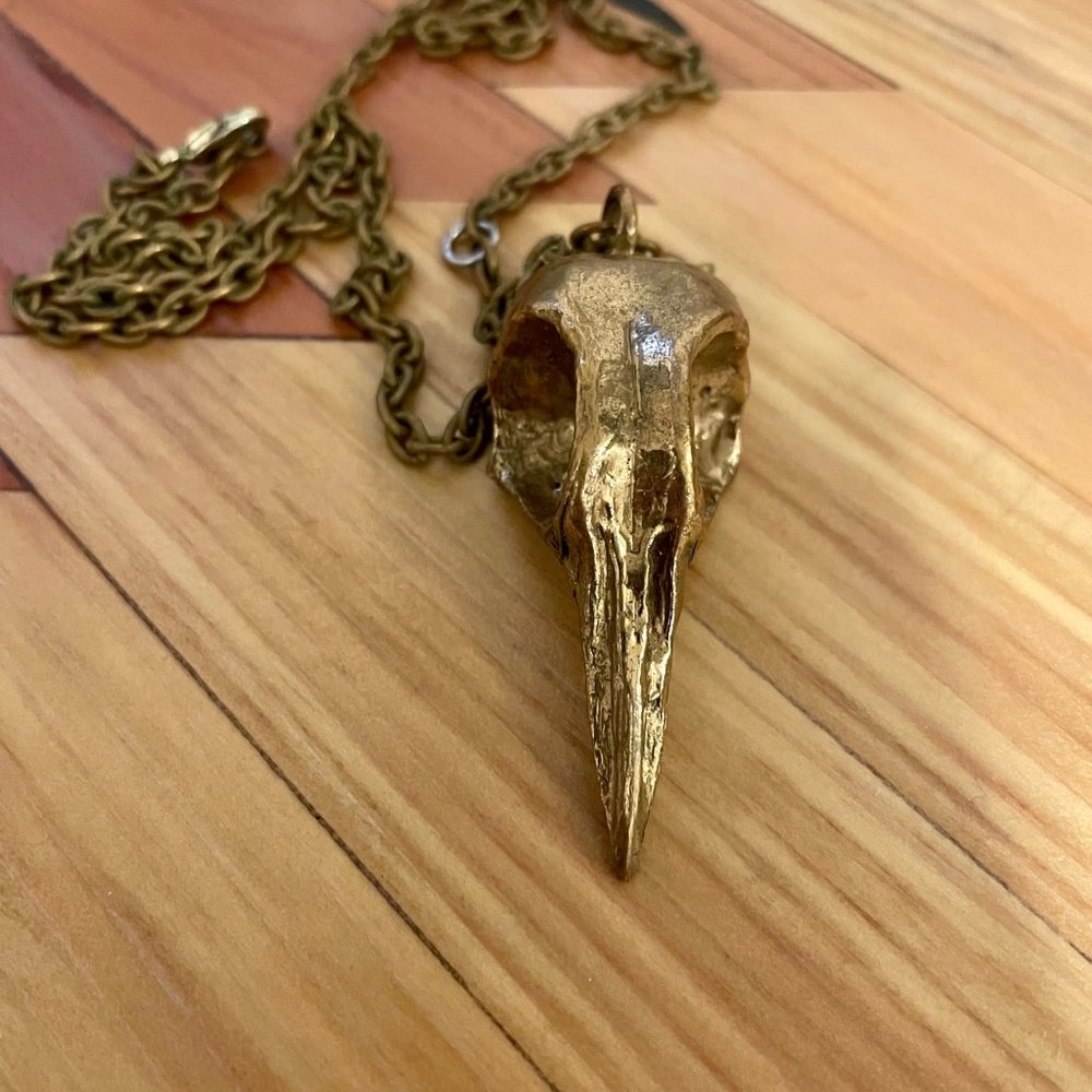 Gold-colored metal bird skull necklace